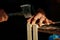 Carpenter at workbench nails down small wooden box.Hands of worker with old axe.Authentic workflow in carpentry workshop