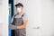 Carpenter worker in medical mask process installation door wood
