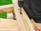 Carpenter working, drill, and wood timber construction woodwork workbench background in carpentry