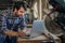 Carpenter working on a laptop in his woodworking studio