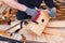 Carpenter working with plane on wooden background. Man hand with professional instrument building construction