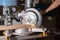 Carpenter working with power circular miter to cut wooden board