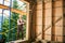 Carpenter working with screwdriver while constructing wooden framed house.