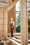 Carpenter working with screwdriver while constructing wooden framed house.