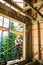 Carpenter working with screwdriver while constructing wooden framed house.