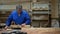 Carpenter working in the Studio, worker planing a tree with a planer