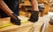 Carpenter working with a wood, marking plank with a pencil and taking measurements to cut a piece of wood to make a piece of