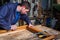 Carpenter working on a Wooden Window Frame in his Workshop