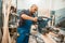 Carpenter works on circular saw, woodworking