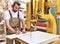 carpenter works in a joinery - workshop for woodworking and sawing