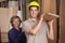 Carpenters Carrying Wooden Plank In Workshop