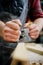 Carpenters experienced wood is using spokeshave to decorate the furniture. Vercion 4