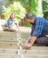 Carpenters Measuring Wood With Tape At Site