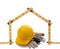 A carpenters ruler in the shape of a house with a hard hat and tools