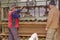 Carpenters tighten the press machine, squeeze wooden profiles smeared with glue, drying process