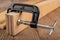 Carpentry clamp used for gluing wood. Carpentry accessories in a home workshop
