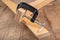 Carpentry clamp used for gluing wood. Carpentry accessories in a home workshop