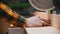 Carpentry - a man woodworker putting a wooden block under the circular saw to cut it