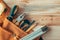 Carpentry tool belt on woodwork workshop desk, top view