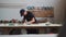 Carpentry works - man worker in protective glasses grinding the angles of a wooden detail