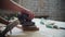 Carpentry works in workshop - man worker grinding the surface of a wooden detail