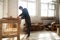 Carpentry workshop. Man using electric hand saw on wooden planks