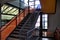 Carpeted office staircase with carpet and metal railings.