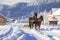 Carriage with horses in winter in village
