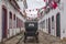 A carriage in a street adorned with flags for the Divine Holy Spirit Festivity in Paraty, Brazil.