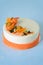 Carrot dessert on a plate. High kitchen. Carrot cake with spicy biscuit, carrot tangerine jelly and cheese mousse