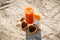 Carrot juice, sunglasses and sun lotion at beach, concept of vitamin A and beautiful, lasting tan