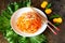 Carrot Korean meat salad with chopsticks on wooden oak table