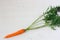 Carrot lying on a light wooden background