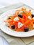 Carrot pasta salad with feta, olivs and dill