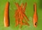 A carrot is shaves of it`s skin and laid down before been cut into pieces