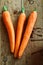 Carrot trio on wood background