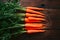 Carrots arranged on kitchen table, vibrant orange freshness displayed