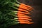 Carrots arranged on kitchen table, vibrant orange freshness displayed