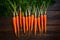 Carrots arranged on kitchen table, vibrant orange freshness displayed