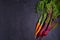 Carrots and beet - root vegetables on a black background. Summer farm vegetables. Food background, layout, room for text.
