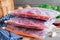 Carrots, beets and onions in a frying pan, around dill, on a brown wooden background. Ingredients for borsch Procurement. Freezing