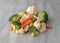 Carrots, broccoli and cauliflower on a marble counter top