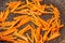 Carrots cut into strips and fried in a hot frying pan close-up