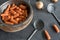 Carrots in metal colander with vintage spoons