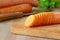 Carrots, sliced in circles, lies on a cutting board on the background of carrots