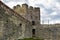 Carrying out restoration work in the ancient medieval fortress. Metal scaffolding is installed next to the old wall