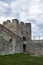 Carrying out restoration work in the ancient medieval fortress. Metal scaffolding is installed next to the old wall to work