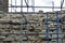 Carrying out restoration work in the ancient medieval fortress. Metal scaffolding is installed next to the old wall to work