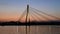 Cars on the cable bridge over sunset sky