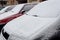 Cars in the city yard covered with snow, close - up-concept of the arrival of cold winter days